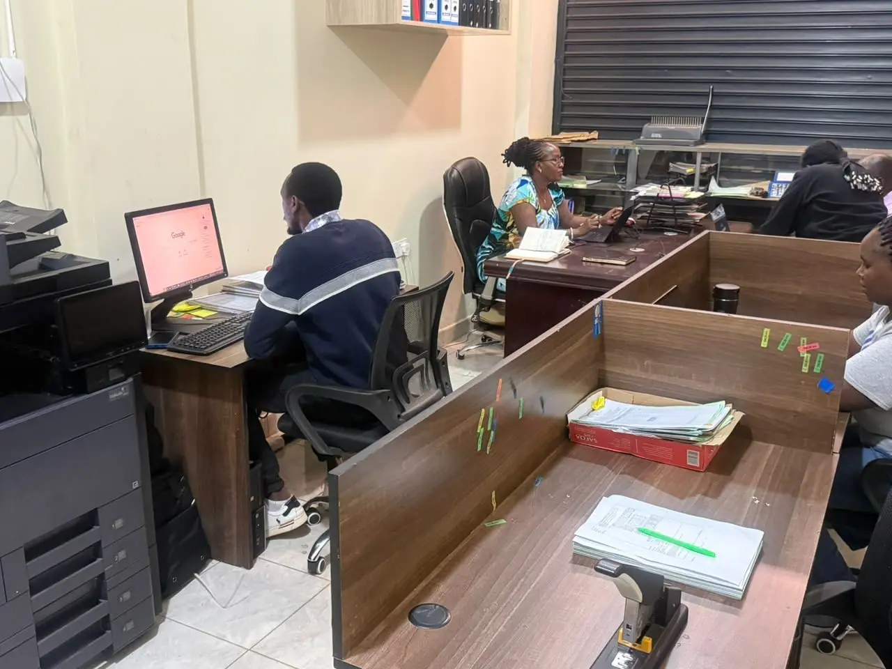Two staff members working at their desks in the Eldoret office