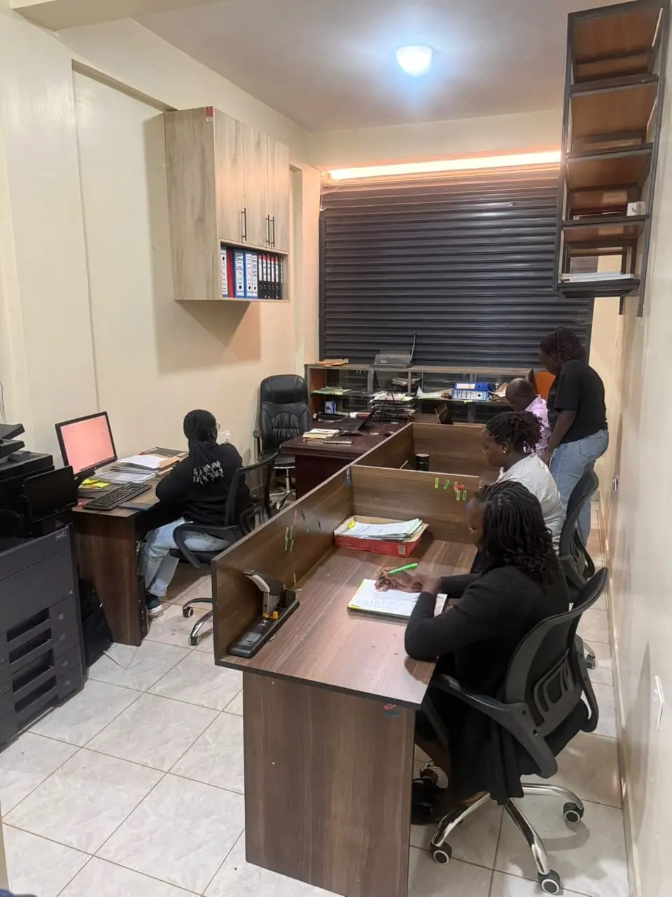 Staff working and conferring across the open-plan office