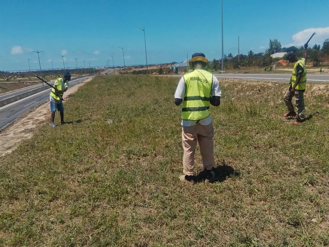 A Kerada crew member strimming grass on the highway embankment