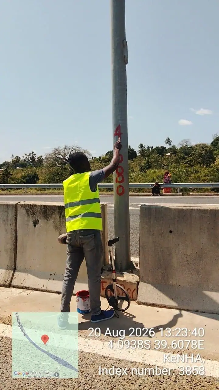 A Kerada crew member marking a distance post on the Mteza–Kibundani road